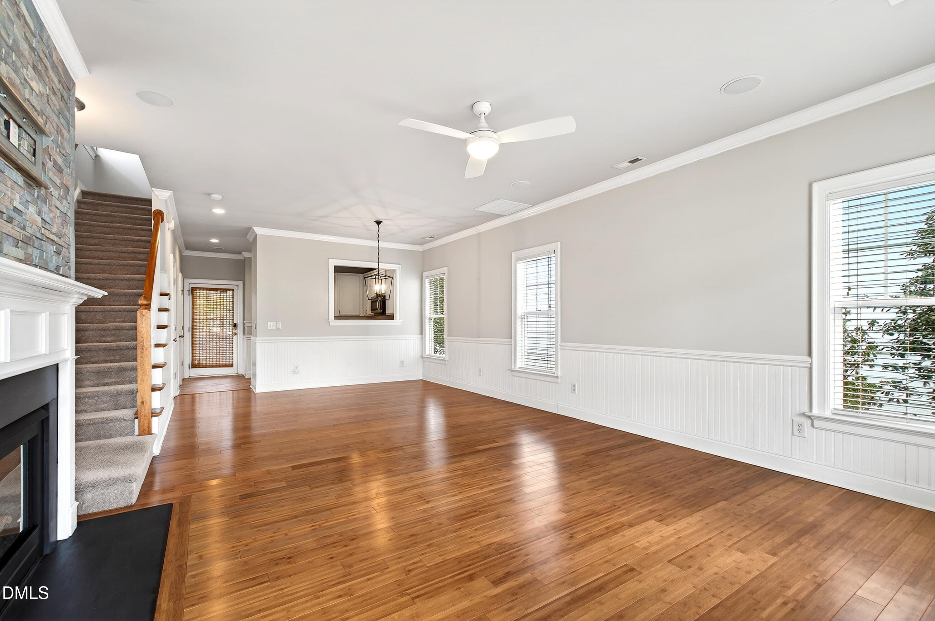 7756 ACC Boulevard Raleigh, NC 27617 - Photo 6 of 40 an empty room with wooden floor and windows