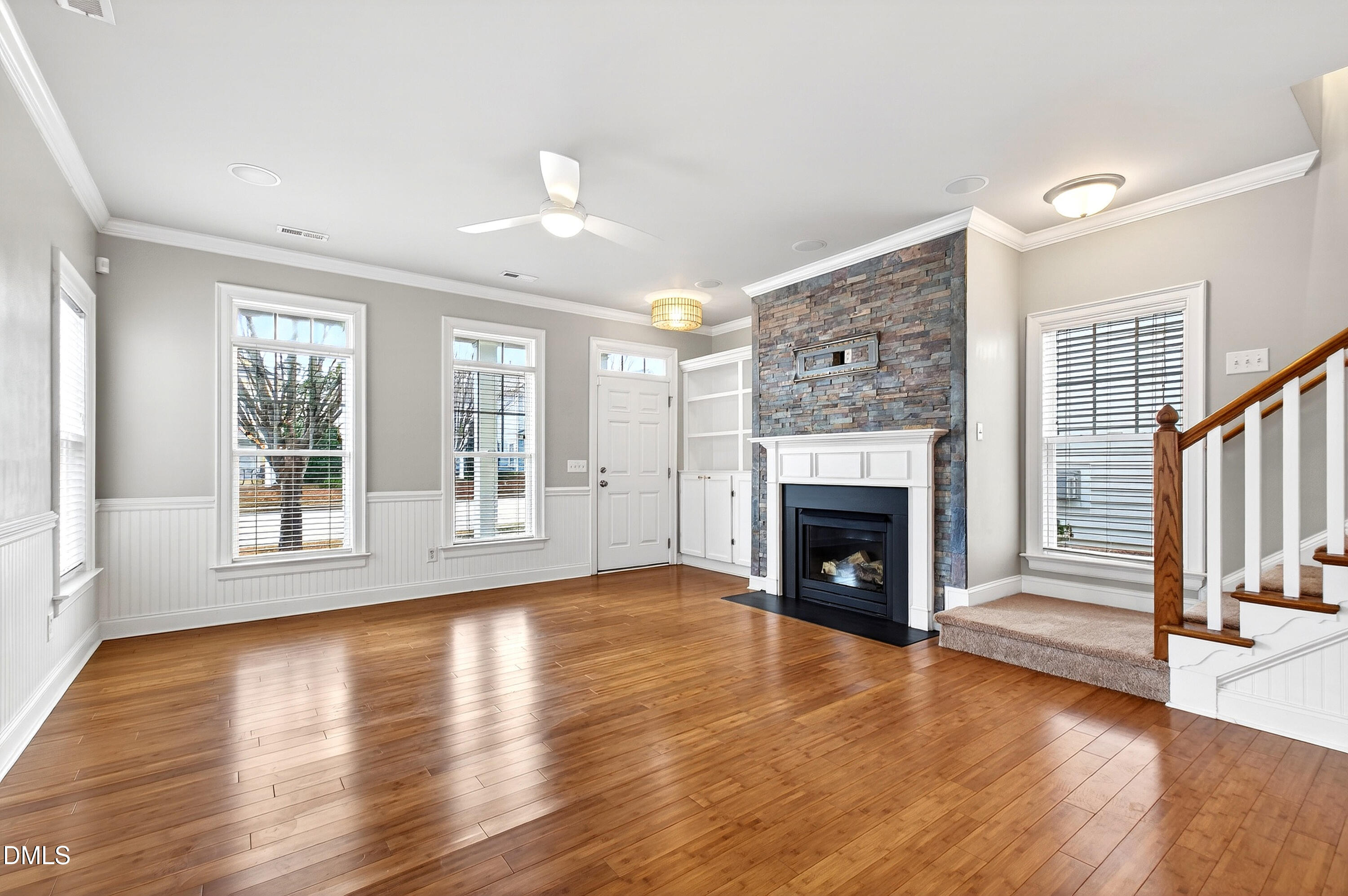 7756 ACC Boulevard Raleigh, NC 27617 - Photo 8 of 40 a view of an empty room with wooden floor fireplace and a window