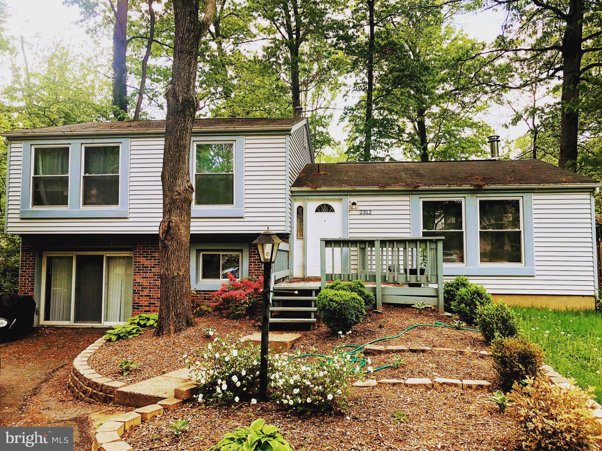 2312 Whitetail Court Reston, VA 20191 - Photo 1 of 26 a front view of a house with garden