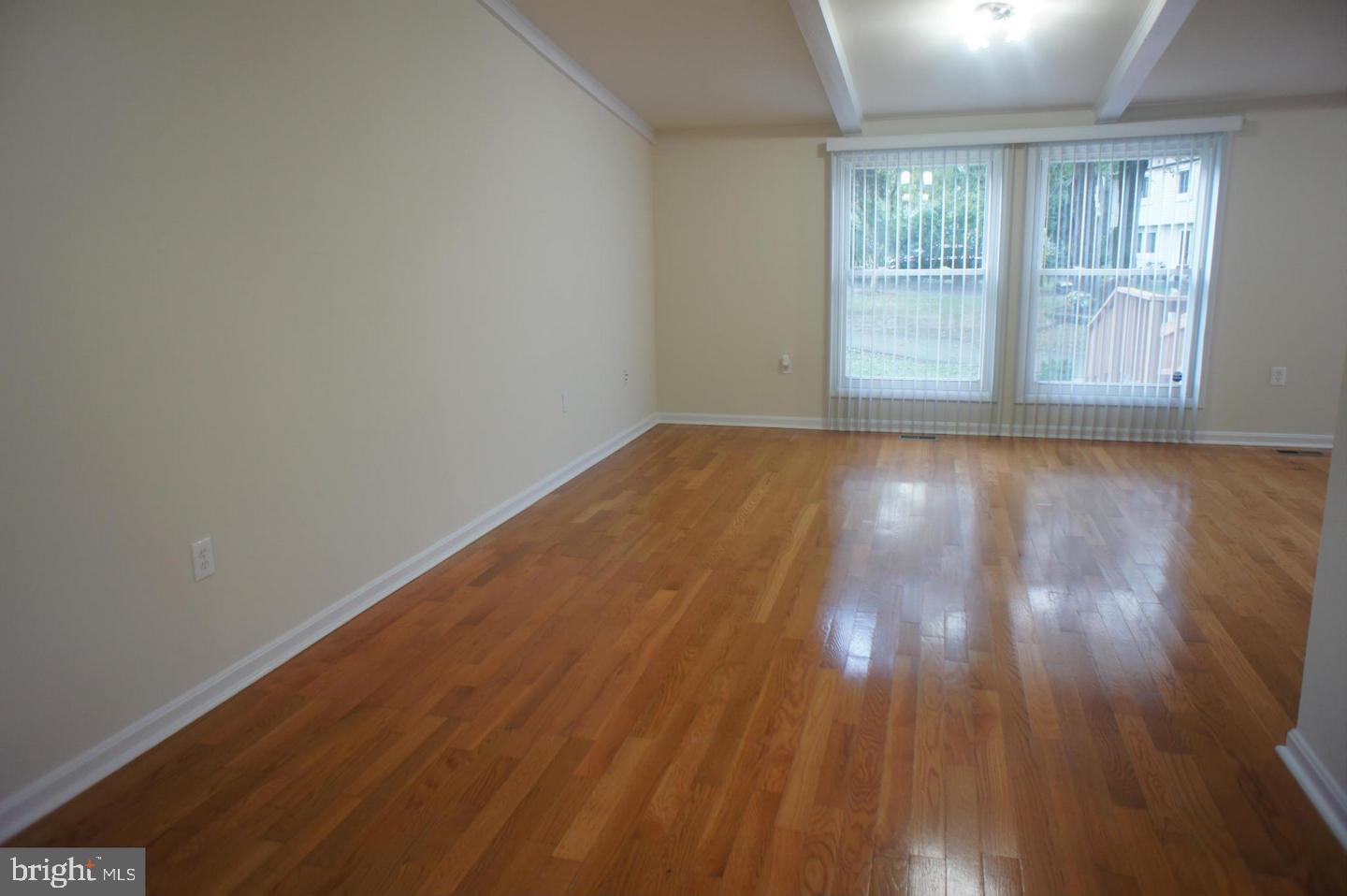 2312 Whitetail Court Reston, VA 20191 - Photo 3 of 26 an empty room with wooden floor and windows