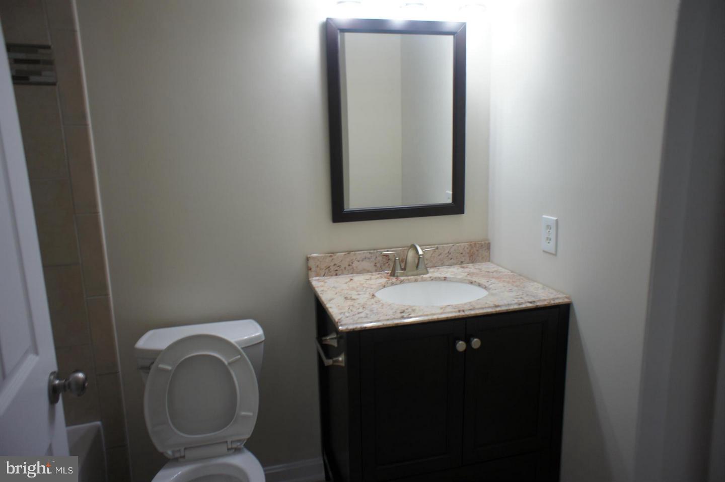 2312 Whitetail Court Reston, VA 20191 - Photo 22 of 26 a bathroom with a toilet sink and mirror