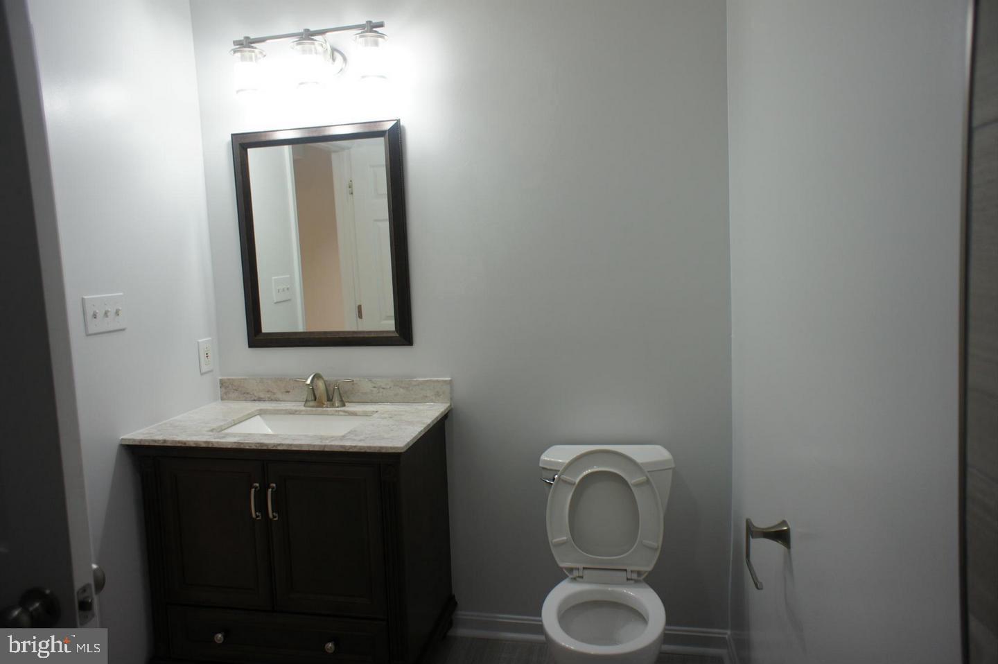 2312 Whitetail Court Reston, VA 20191 - Photo 23 of 26 a bathroom with a toilet sink and mirror