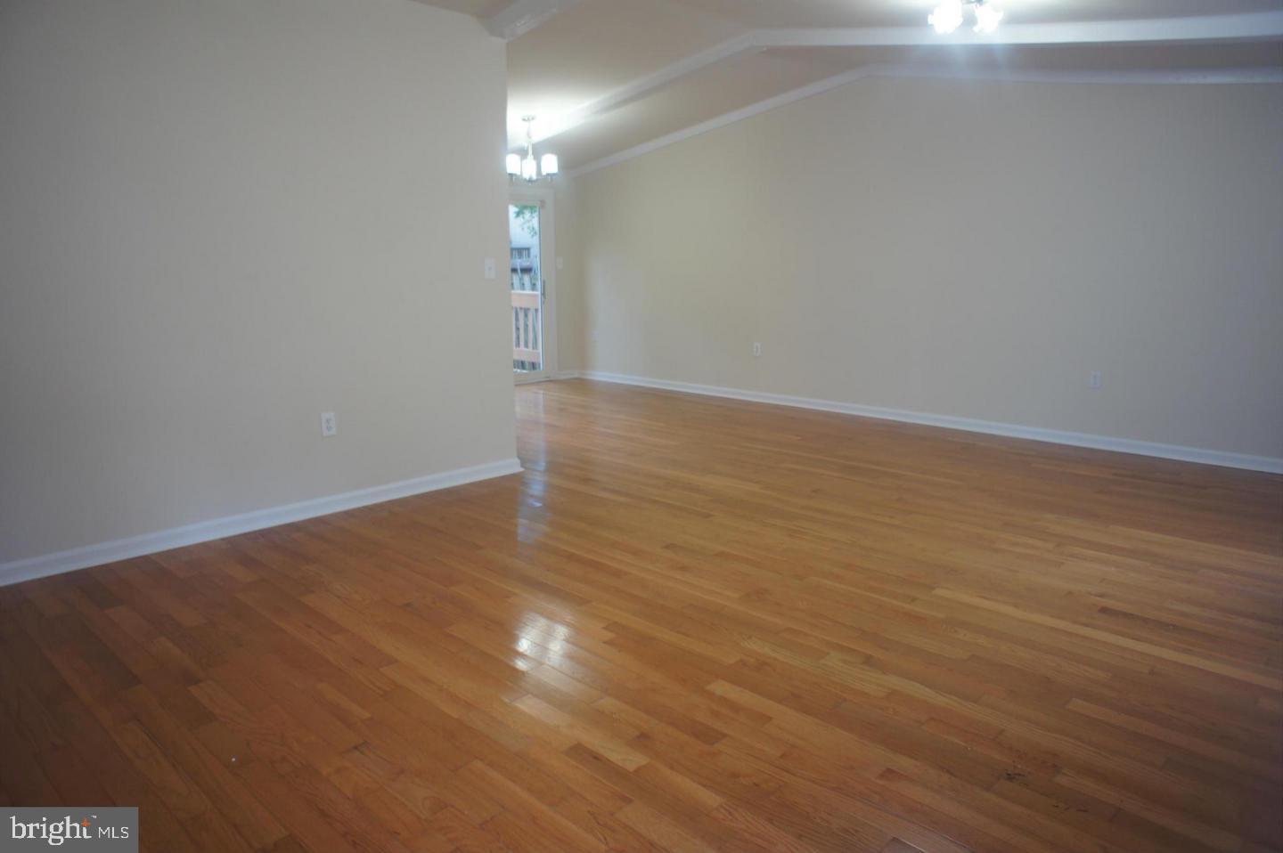 2312 Whitetail Court Reston, VA 20191 - Photo 4 of 26 a view of an empty room with wooden floor