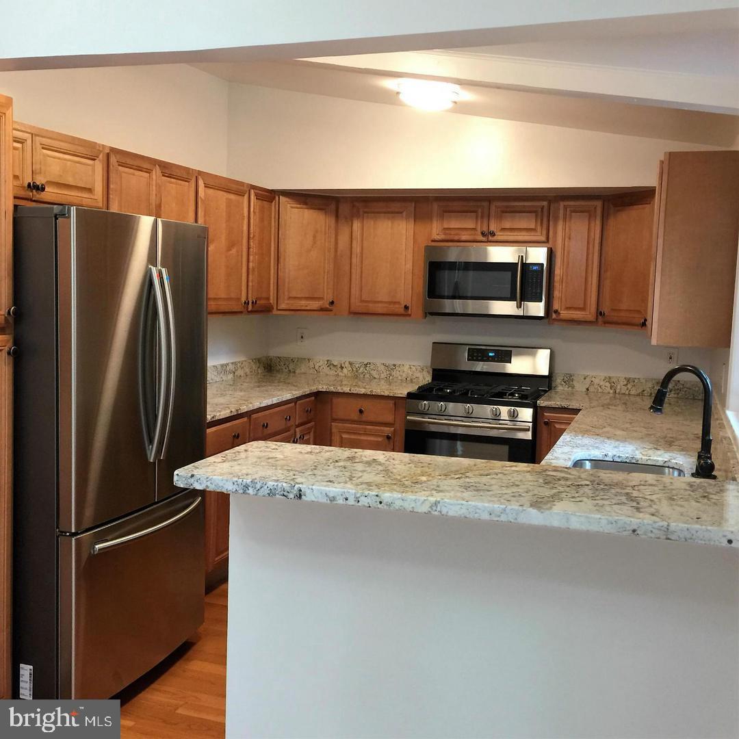 2312 Whitetail Court Reston, VA 20191 - Photo 8 of 26 a kitchen with a refrigerator sink and microwave