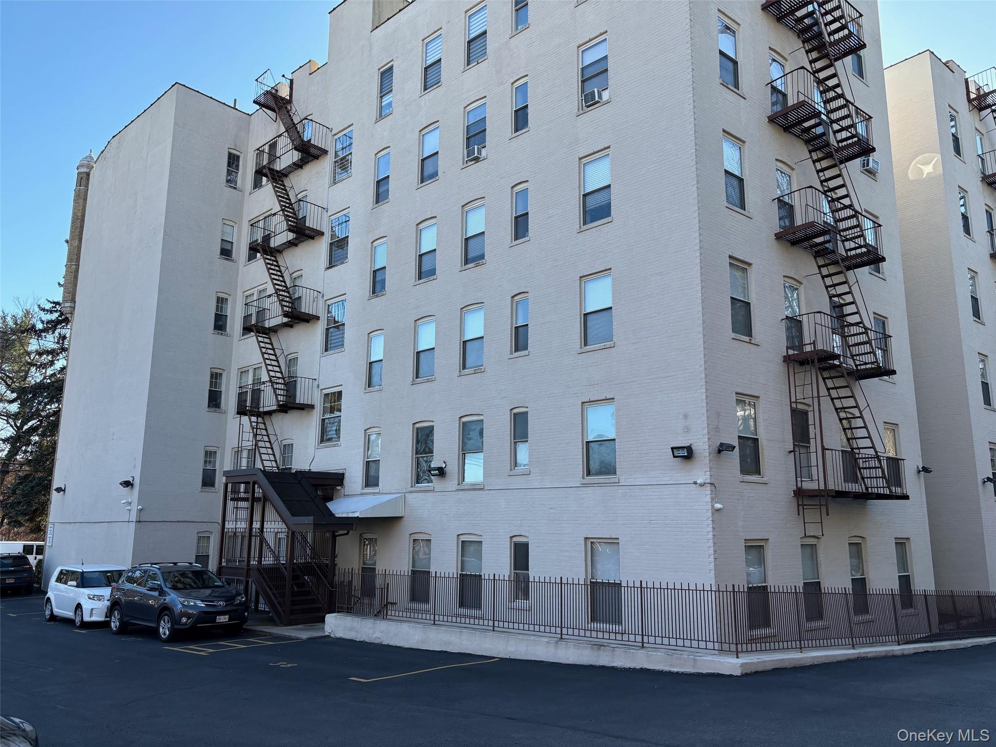 85 Bronx River Road, Unit 3S Yonkers, NY 10704 - Photo 23 of 27 View of apartment building / complex with back entrance and uncovered parking