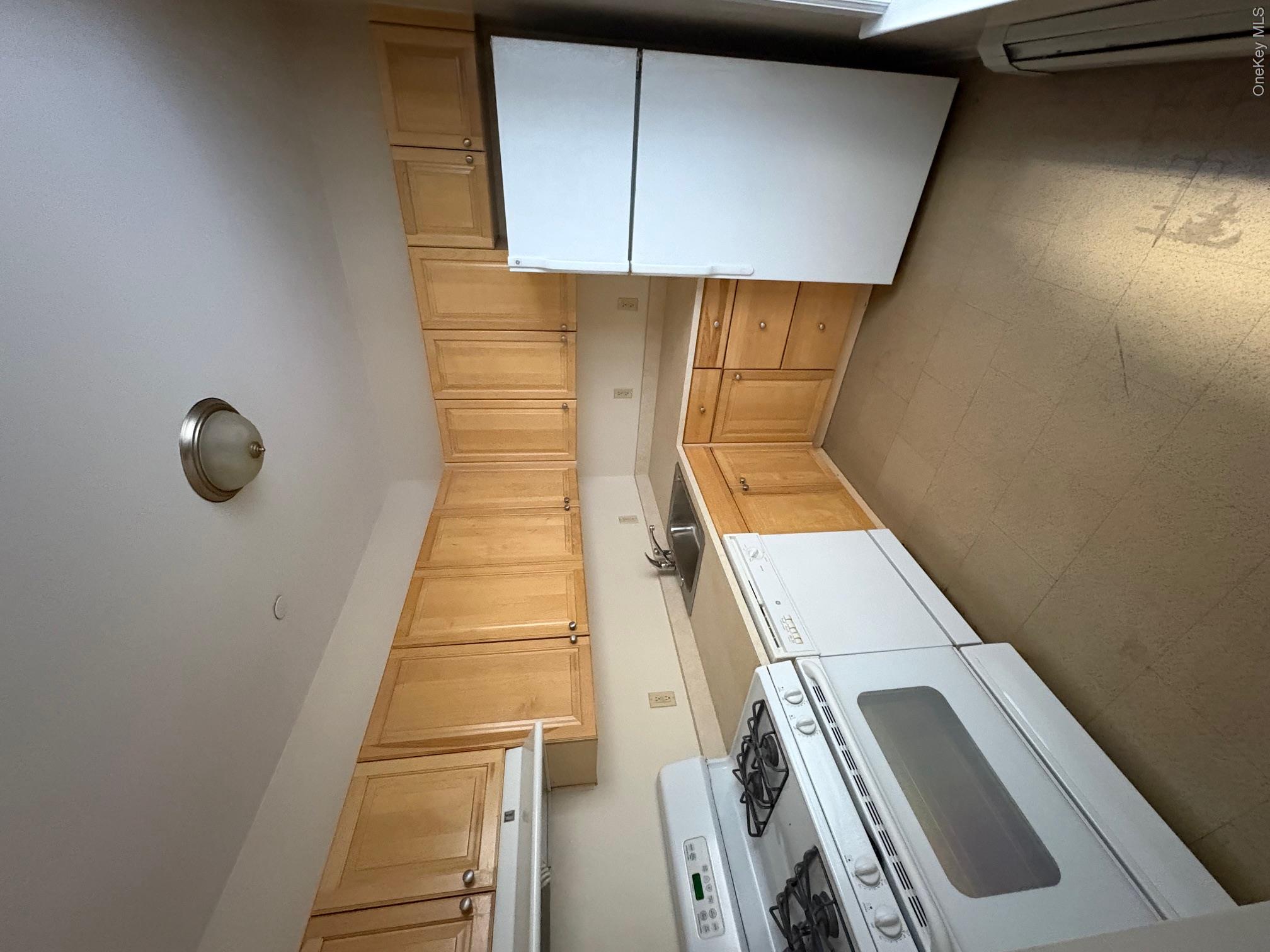 85 Bronx River Road, Unit 3S Yonkers, NY 10704 - Photo 8 of 27 Kitchen with range, light brown cabinetry, light flooring, refrigerator, and light countertops