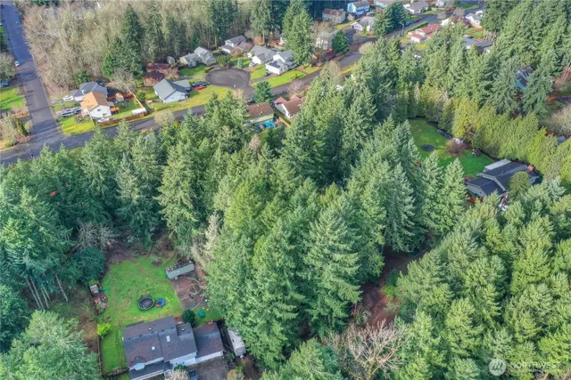 an aerial view of a house with a yard swimming pool and outdoor seating