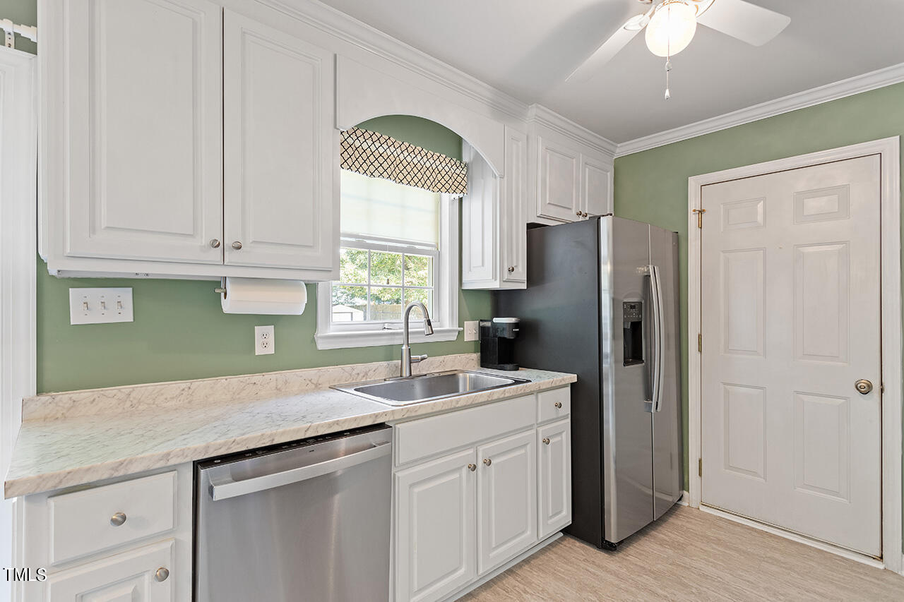 2001 Eagle View Drive Wendell, NC 27591 - Photo 17 of 33 a kitchen with stainless steel appliances granite countertop a sink a refrigerator a center island and a window