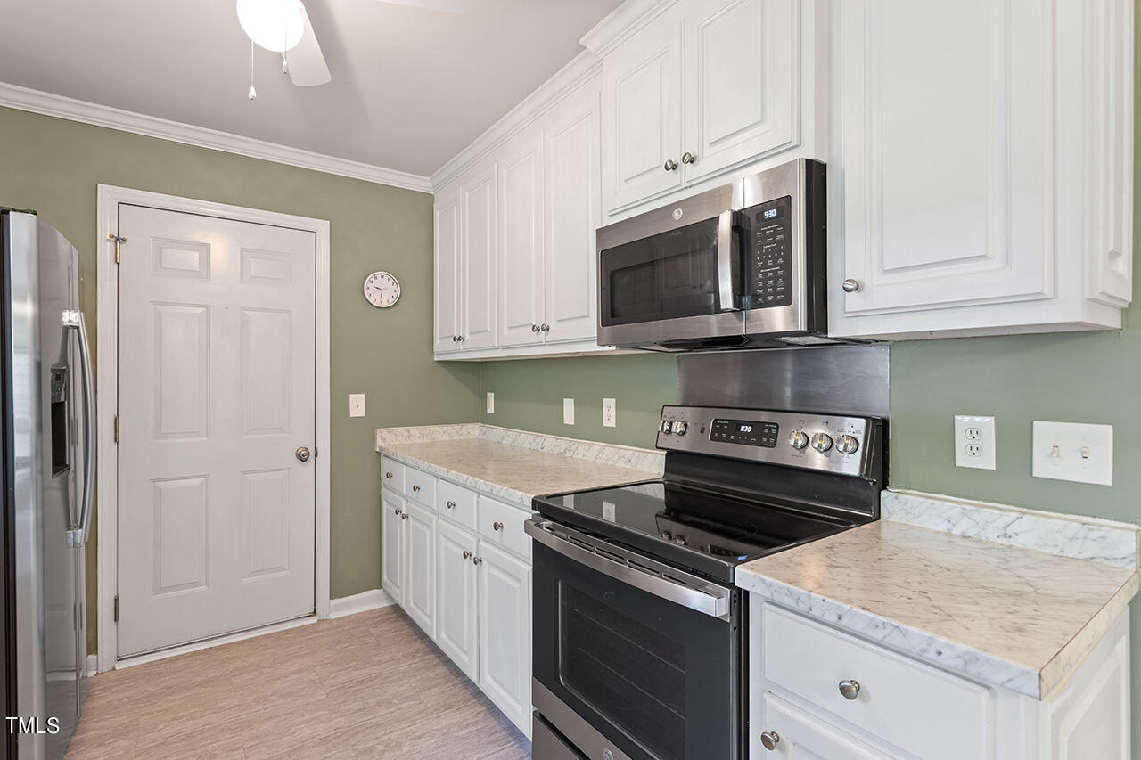 2001 Eagle View Drive Wendell, NC 27591 - Photo 18 of 33 a kitchen with stainless steel appliances granite countertop a stove and a microwave
