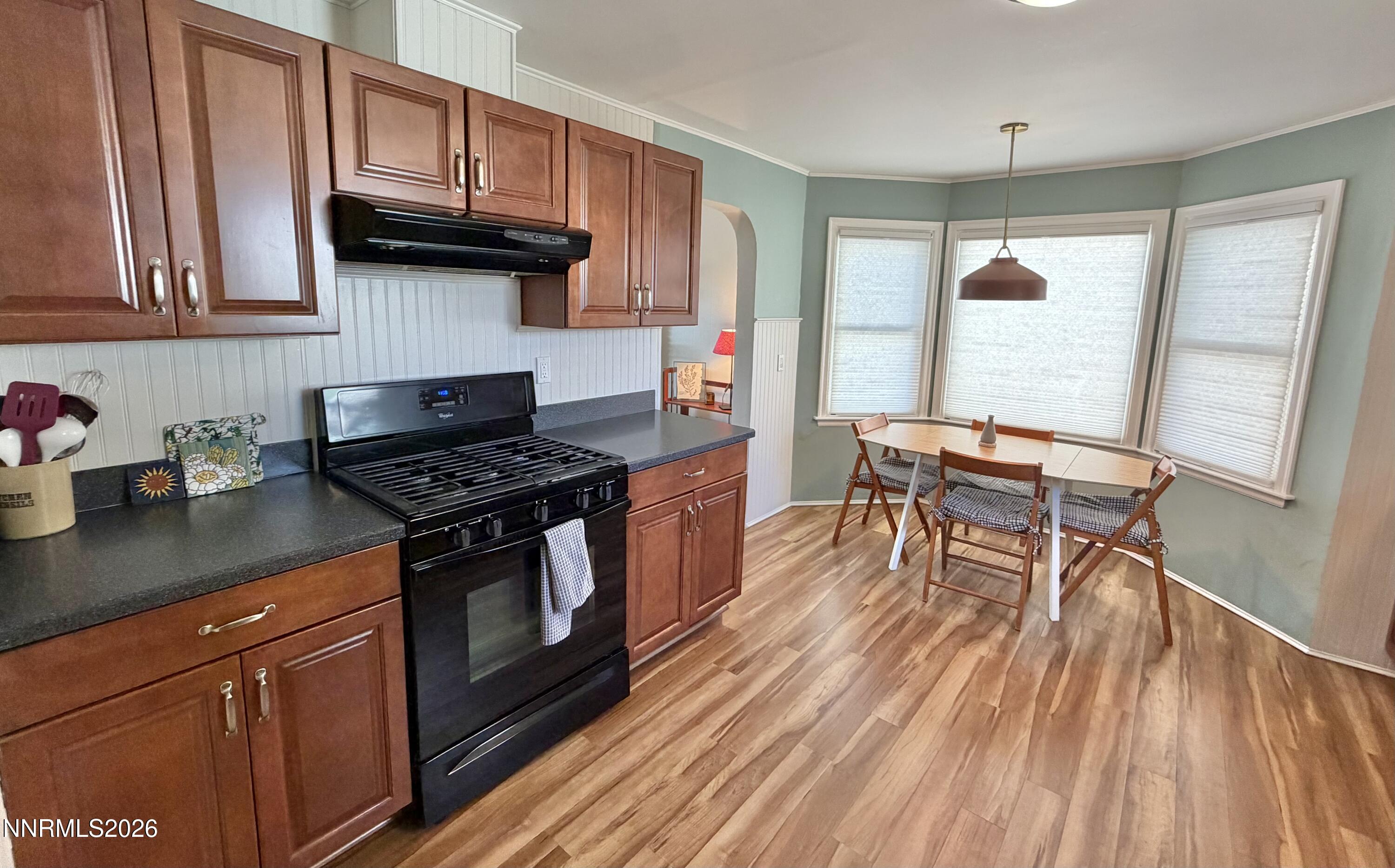 525 East Taylor Street Reno, NV 89502 - Photo 11 of 30 a kitchen with granite countertop wooden floors appliances and cabinets