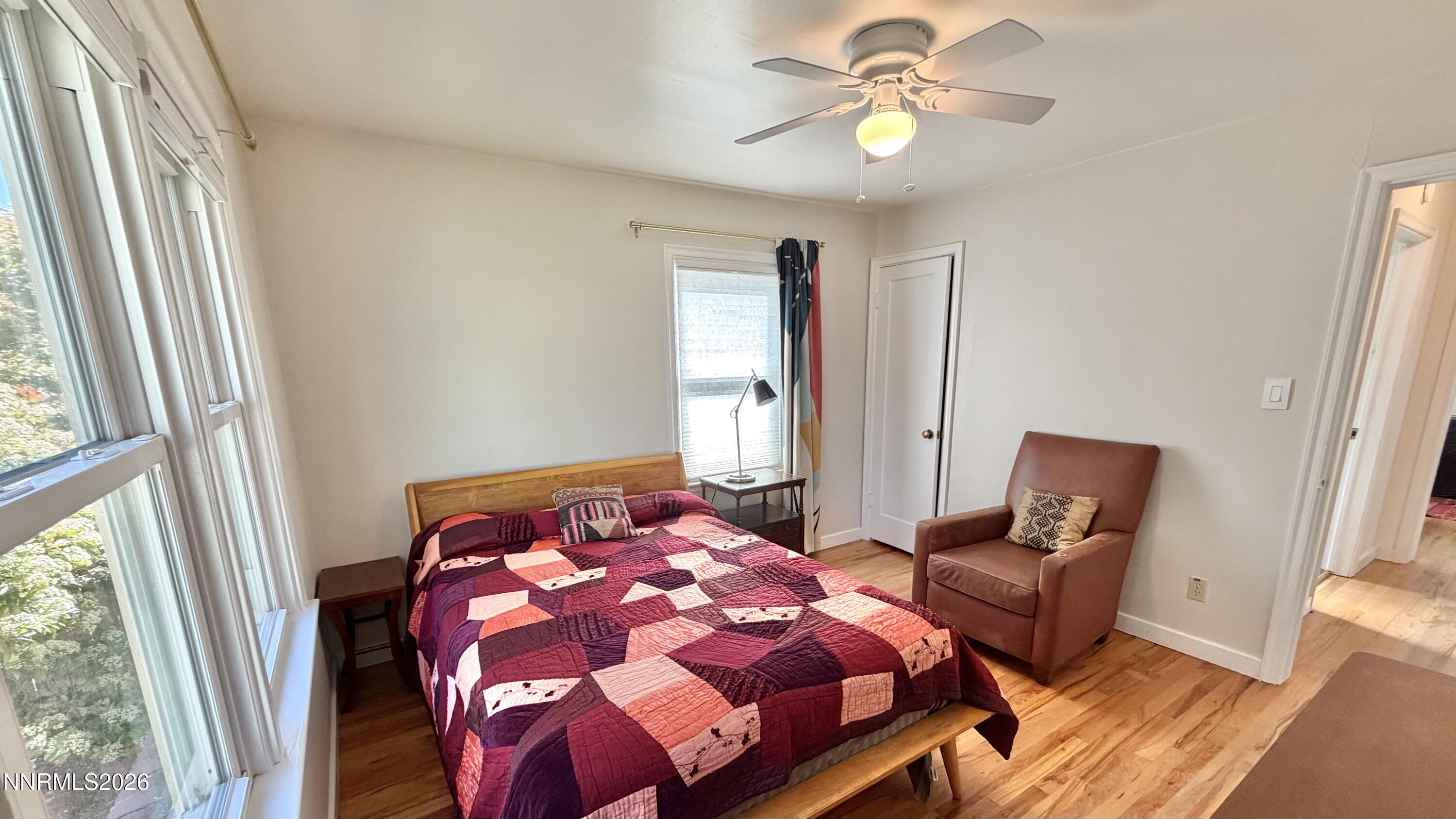 525 East Taylor Street Reno, NV 89502 - Photo 13 of 30 a bedroom with a bed and a chandelier