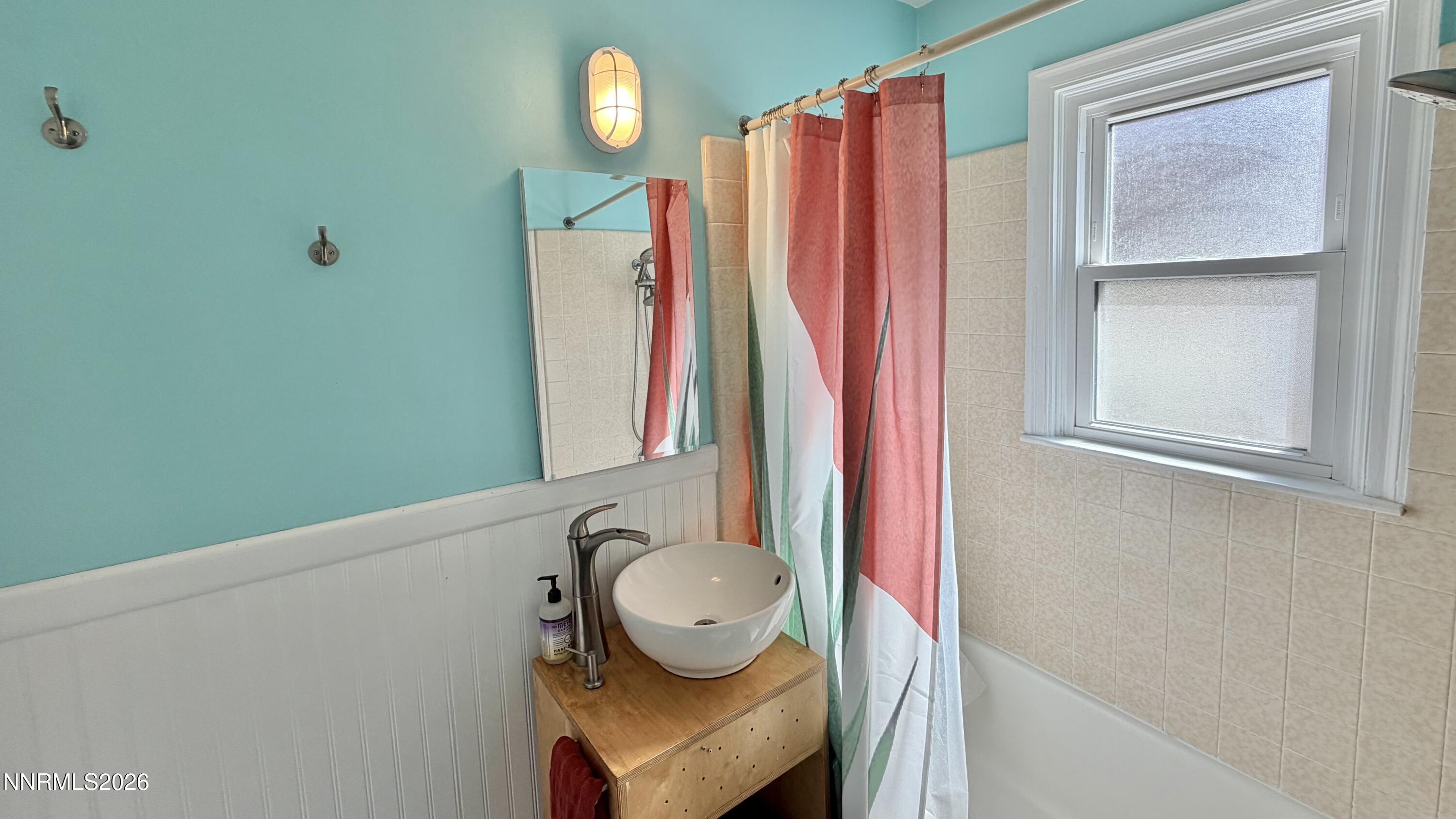 525 East Taylor Street Reno, NV 89502 - Photo 19 of 30 a bathroom with a sink a toilet and shower curtain