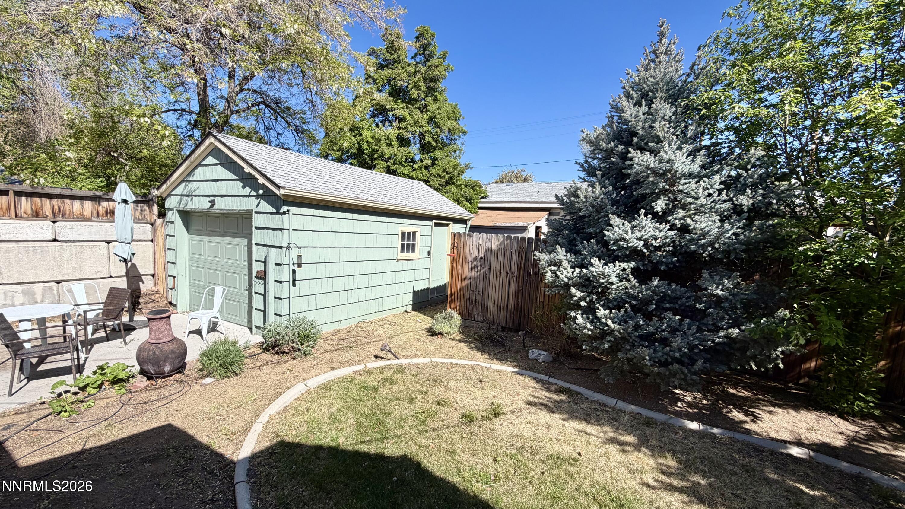 525 East Taylor Street Reno, NV 89502 - Photo 21 of 30 a backyard of a house with table and chairs under an umbrella