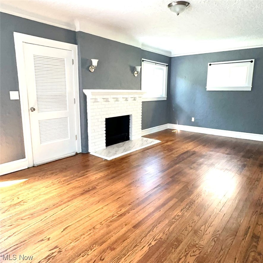 1055 Hillstone Road Cleveland Heights, OH 44121 - Photo 5 of 16 Hardwood floored living room featuring a textured ceiling and a fireplace
