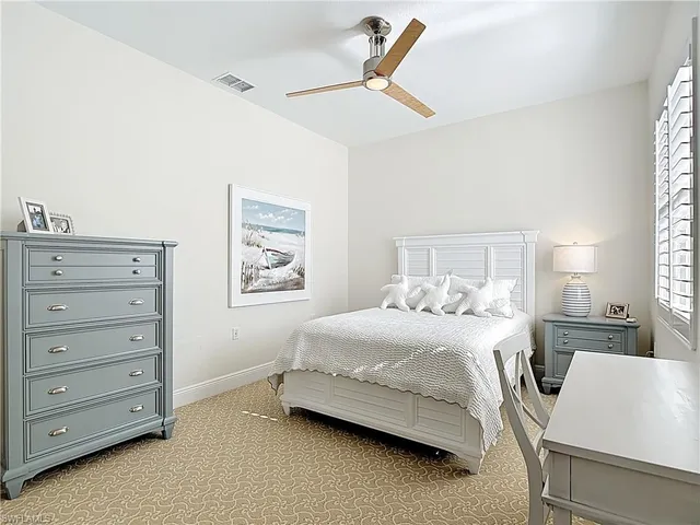a bathroom with a shower sink vanity mirror and toilet