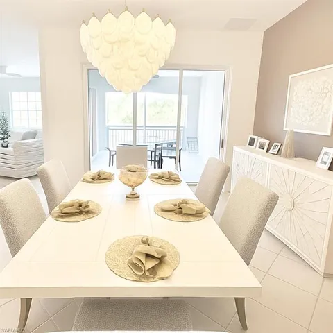 a dining room with furniture and a large window