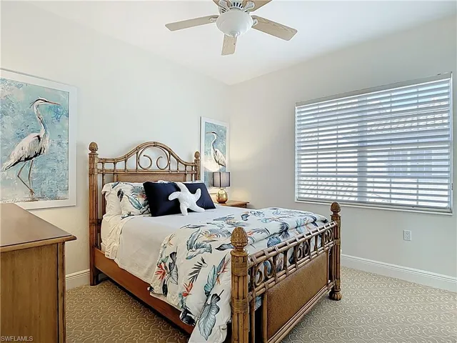 a bedroom with furniture and a large window