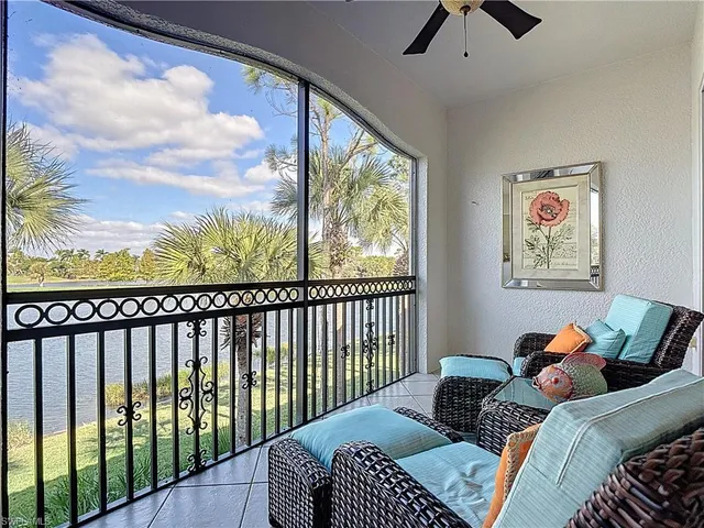 a view of a white house with a large tree