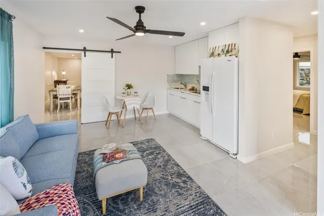 a living room with furniture and kitchen view