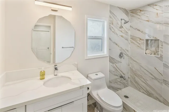 a bathroom with a sink a toilet and a mirror