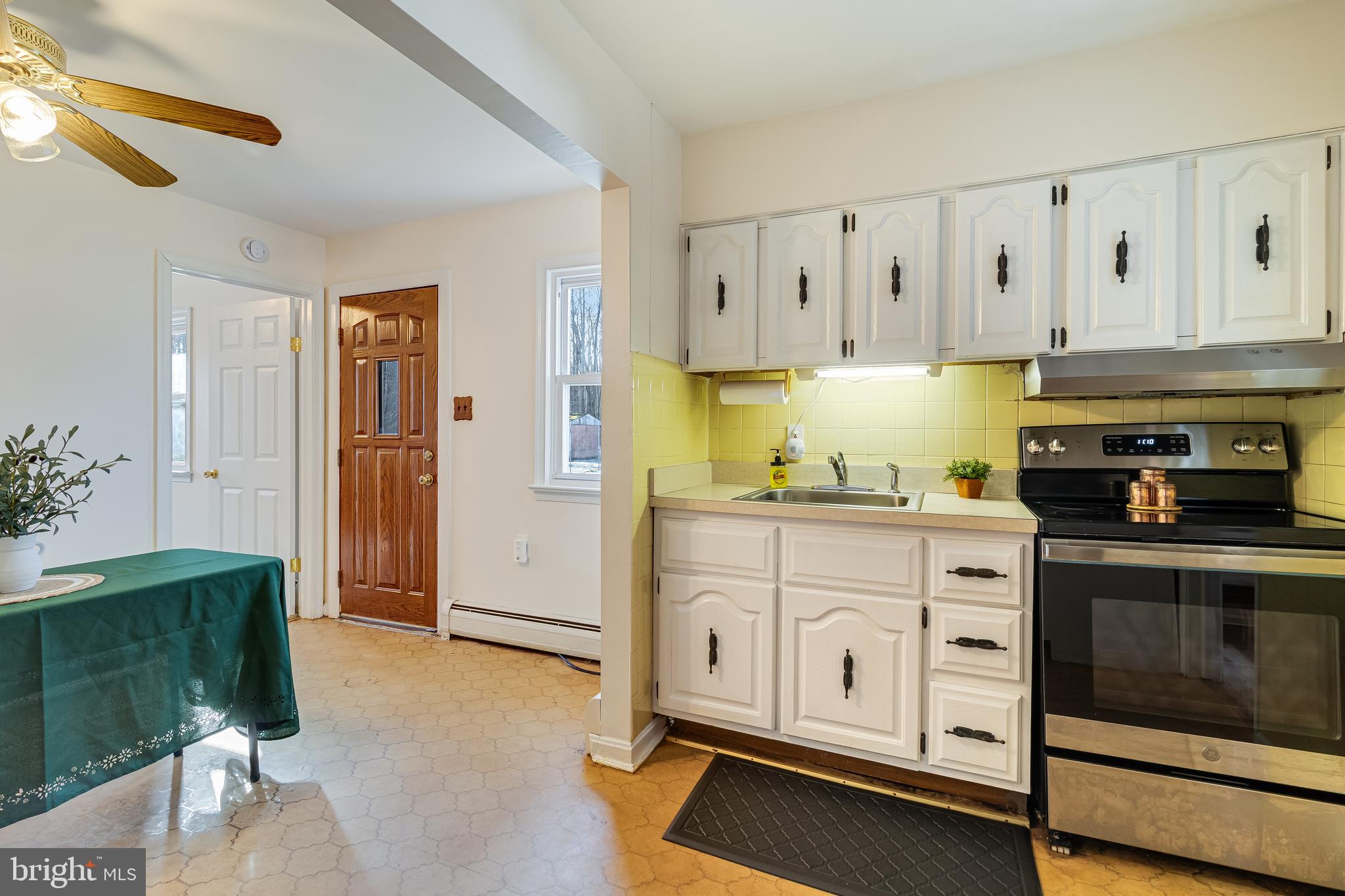 965 Franklin Manor Road Churchton, MD 20733 - Photo 17 of 34 a kitchen with granite countertop white cabinets and white appliances