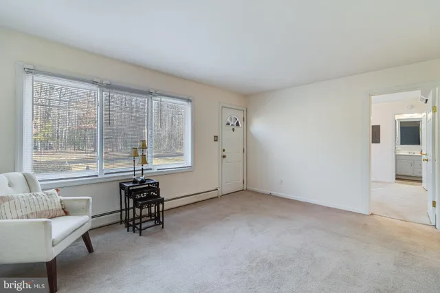 a view of room with window and furniture