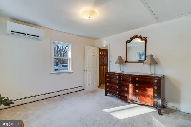 a room with a dresser and a window