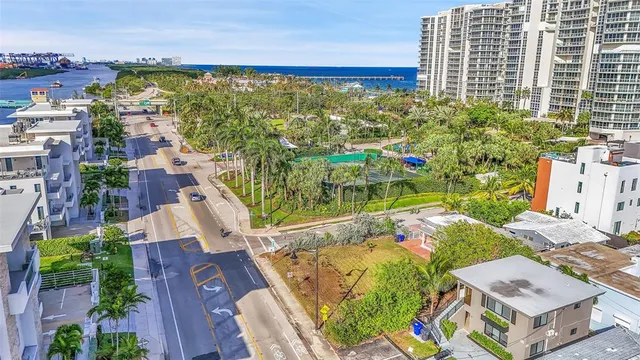 an aerial view of residential houses with outdoor space and street view