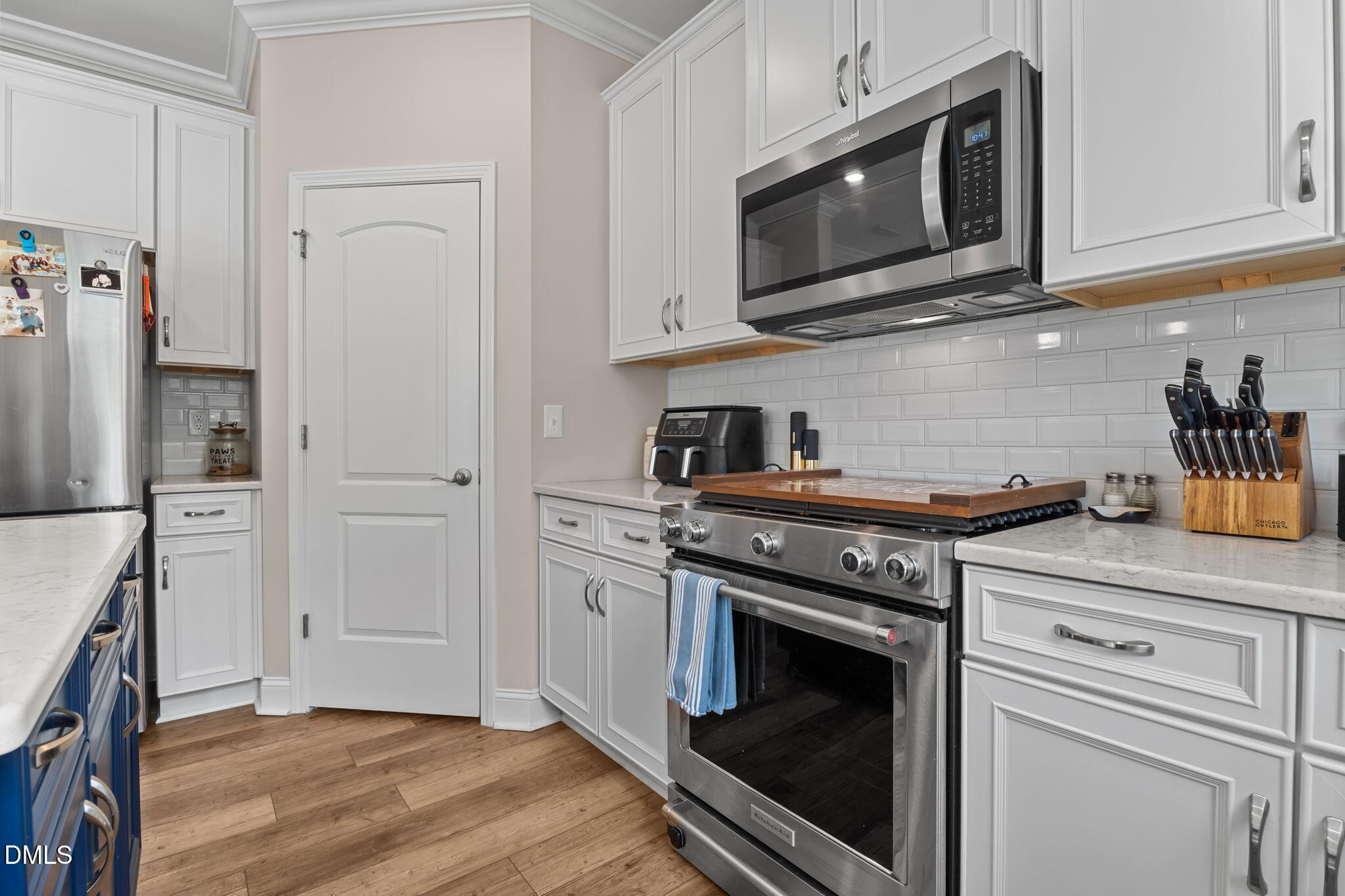 145 Shadowdale Lane Rolesville, NC 27571 - Photo 16 of 43 a kitchen with stainless steel appliances granite countertop white cabinets and a stove top oven