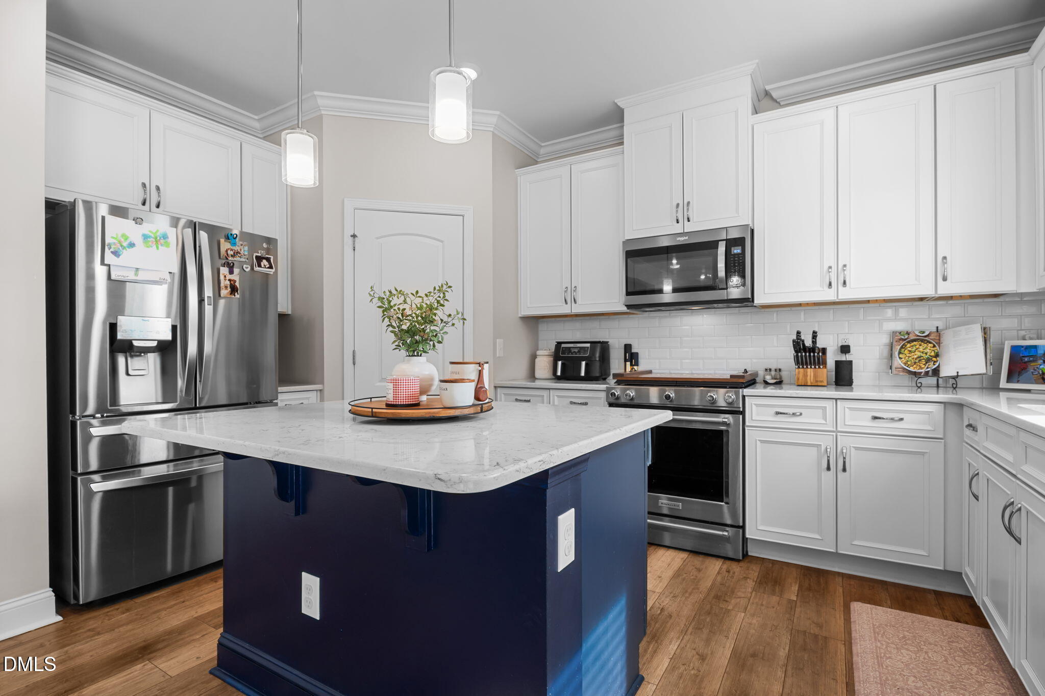 145 Shadowdale Lane Rolesville, NC 27571 - Photo 18 of 43 a kitchen with stainless steel appliances granite countertop a refrigerator a stove a sink a microwave and white cabinets