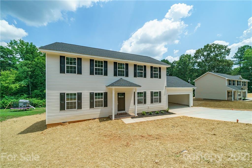 1802 Love Road Monroe, NC 28110 - Photo 2 of 48 a front view of a house with a yard
