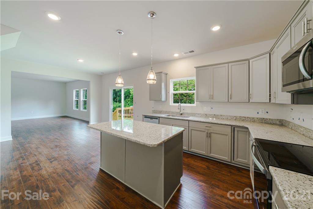 1802 Love Road Monroe, NC 28110 - Photo 14 of 48 a kitchen with granite countertop a sink stainless steel appliances and cabinets