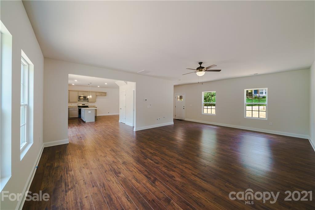1802 Love Road Monroe, NC 28110 - Photo 15 of 48 wooden floor in an empty room with a window