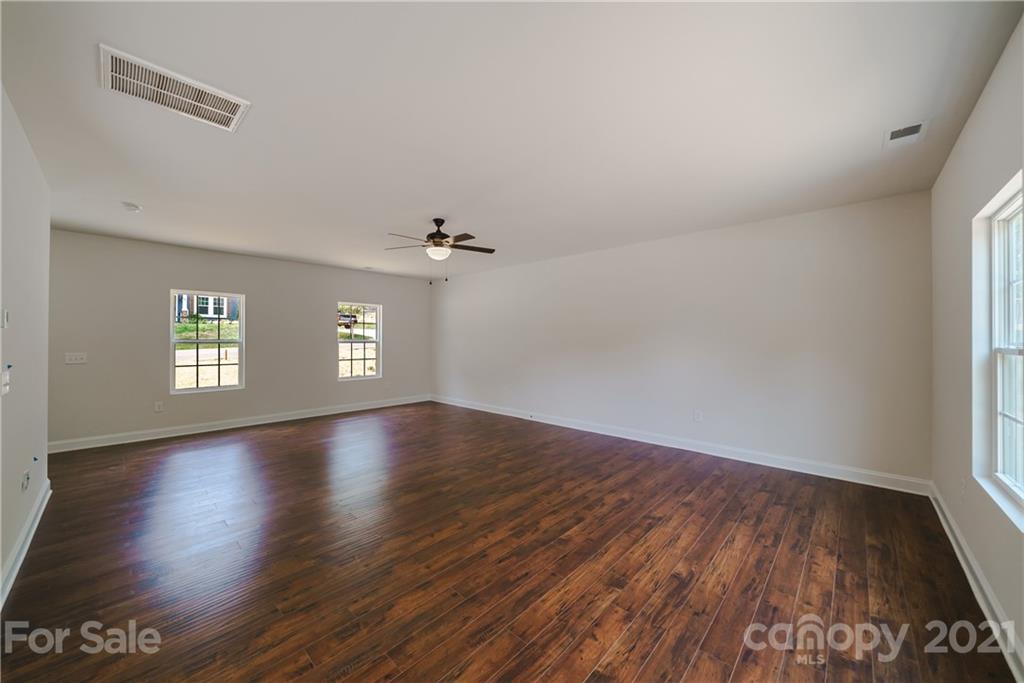 1802 Love Road Monroe, NC 28110 - Photo 16 of 48 an empty room with wooden floor and windows