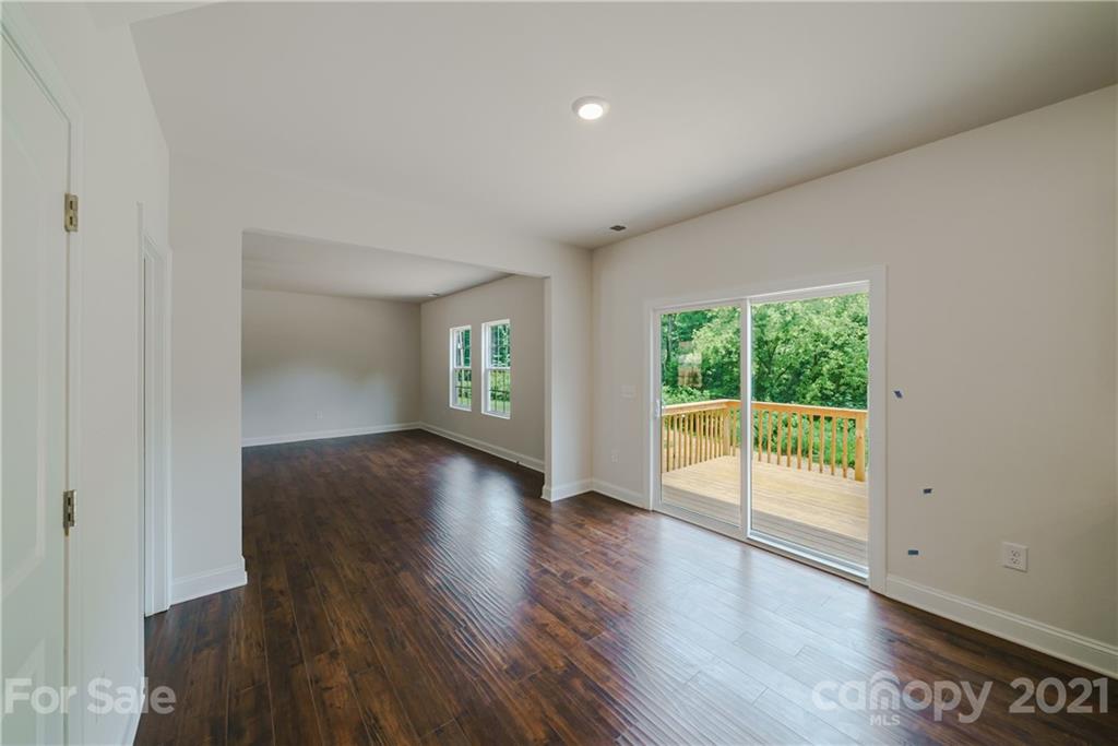 1802 Love Road Monroe, NC 28110 - Photo 18 of 48 a view of an empty room with wooden floor and a window