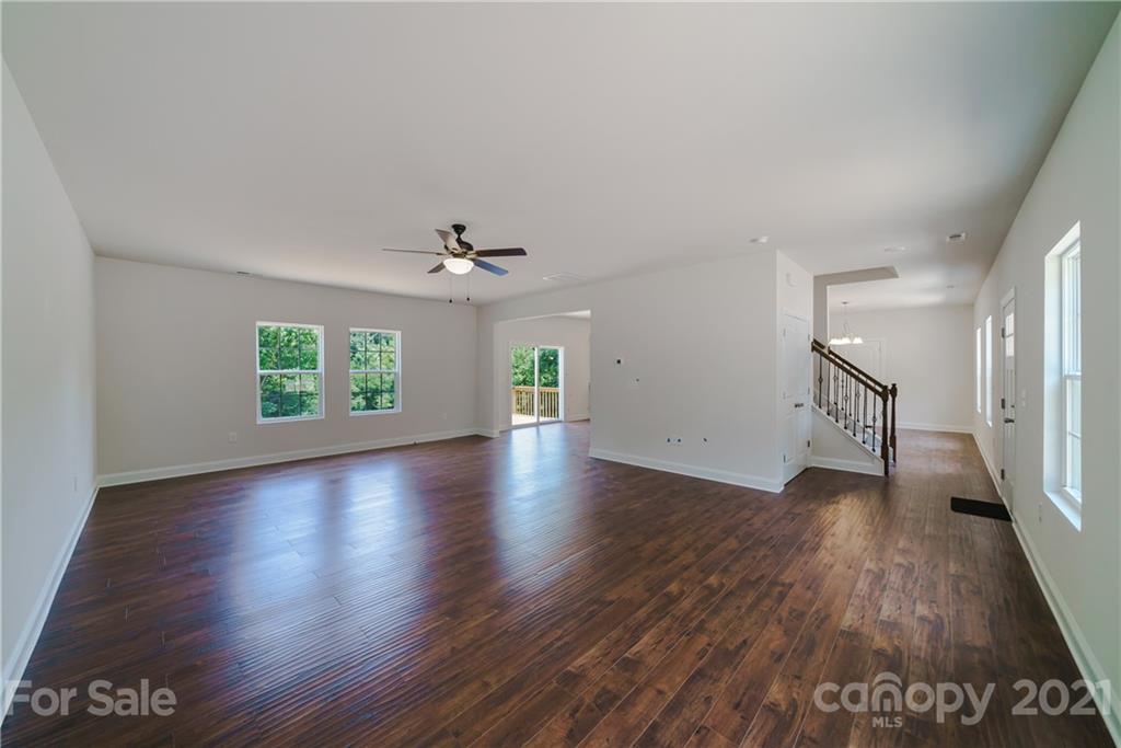 1802 Love Road Monroe, NC 28110 - Photo 19 of 48 an empty room with wooden floor and chandelier