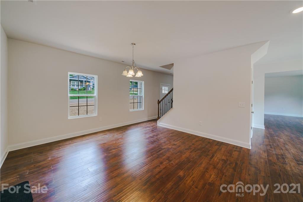 1802 Love Road Monroe, NC 28110 - Photo 20 of 48 an empty room with wooden floor and windows