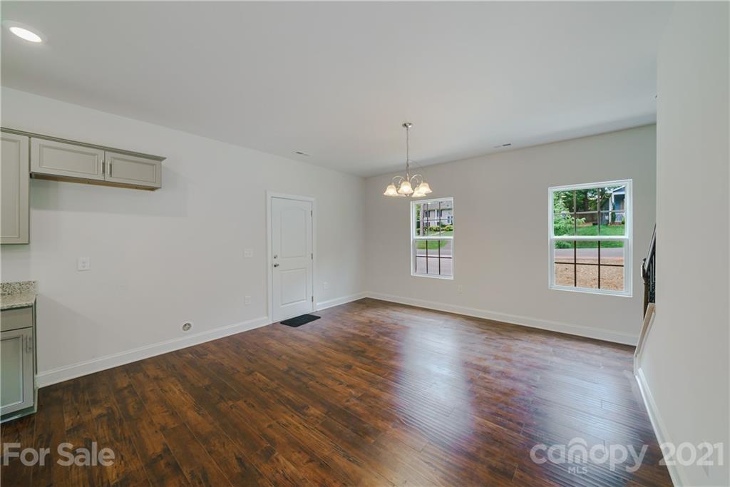 1802 Love Road Monroe, NC 28110 - Photo 21 of 48 an empty room with wooden floor and windows