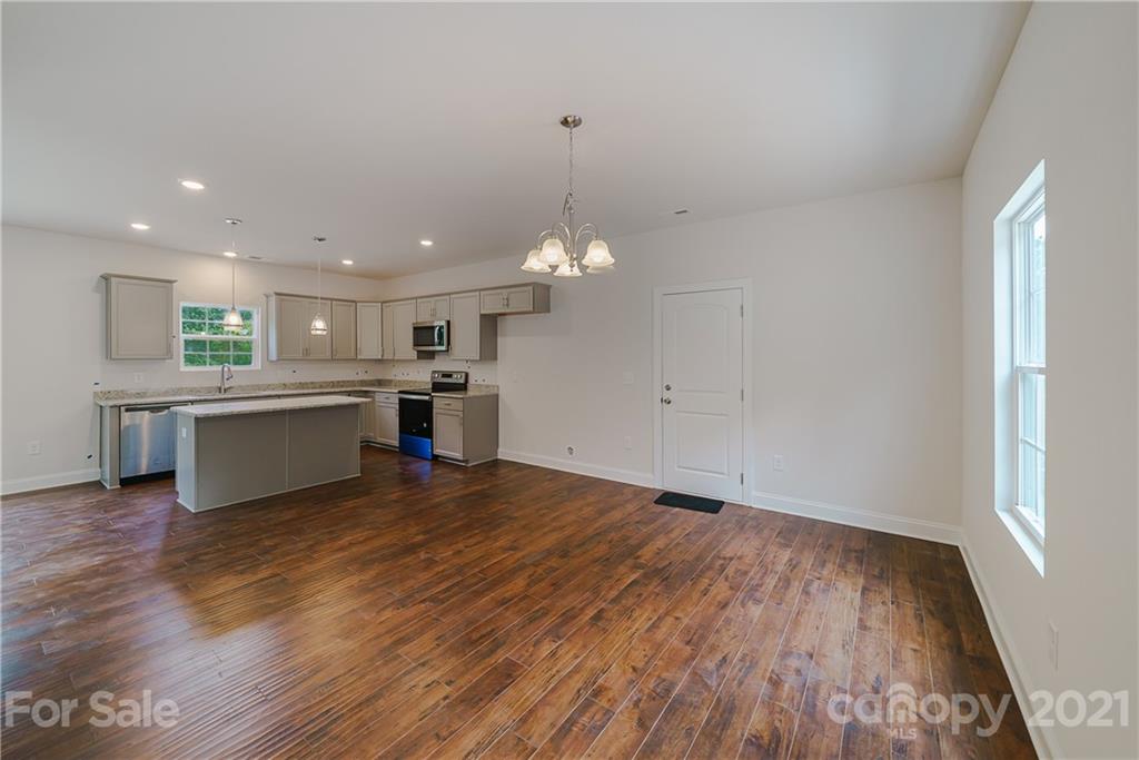 1802 Love Road Monroe, NC 28110 - Photo 22 of 48 a view of a kitchen with a microwave and a stove