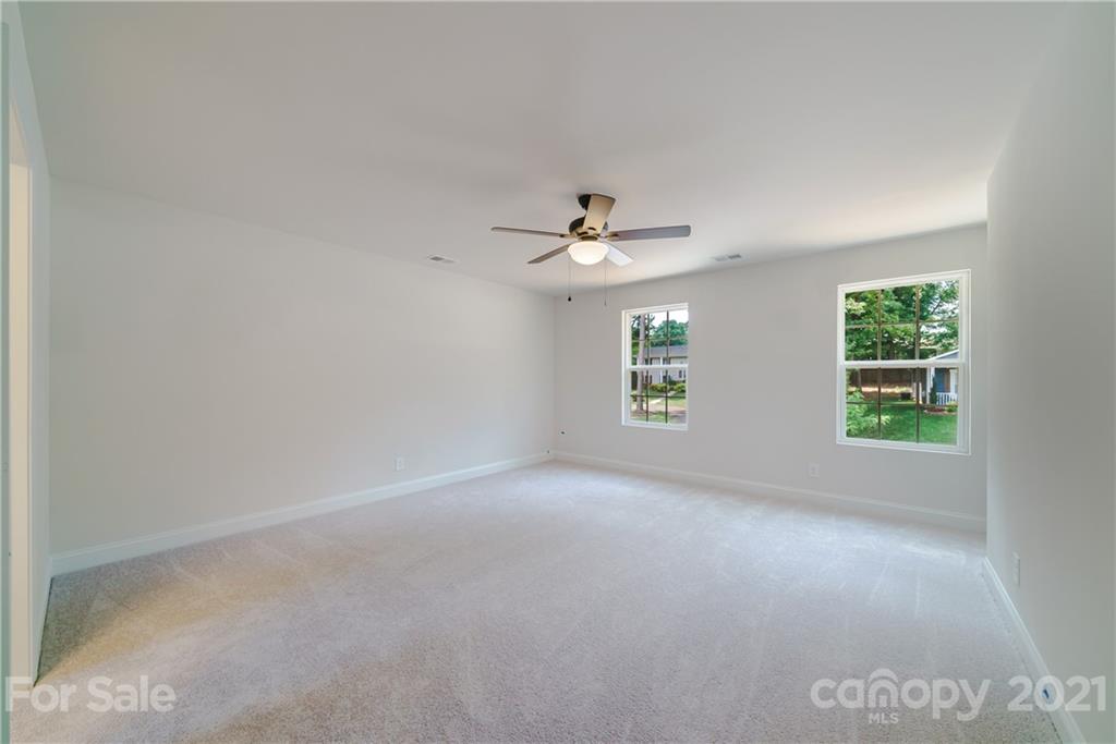 1802 Love Road Monroe, NC 28110 - Photo 25 of 48 an empty room with windows and chandelier fan