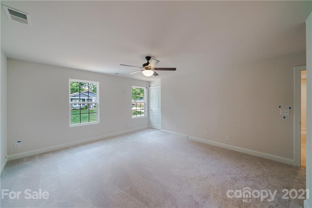 1802 Love Road Monroe, NC 28110 - Photo 26 of 48 an empty room with windows and chandelier fan