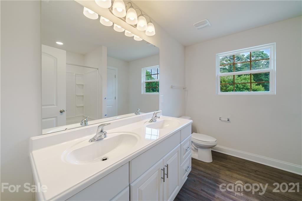 1802 Love Road Monroe, NC 28110 - Photo 27 of 48 a bathroom with a sink a toilet and a mirror