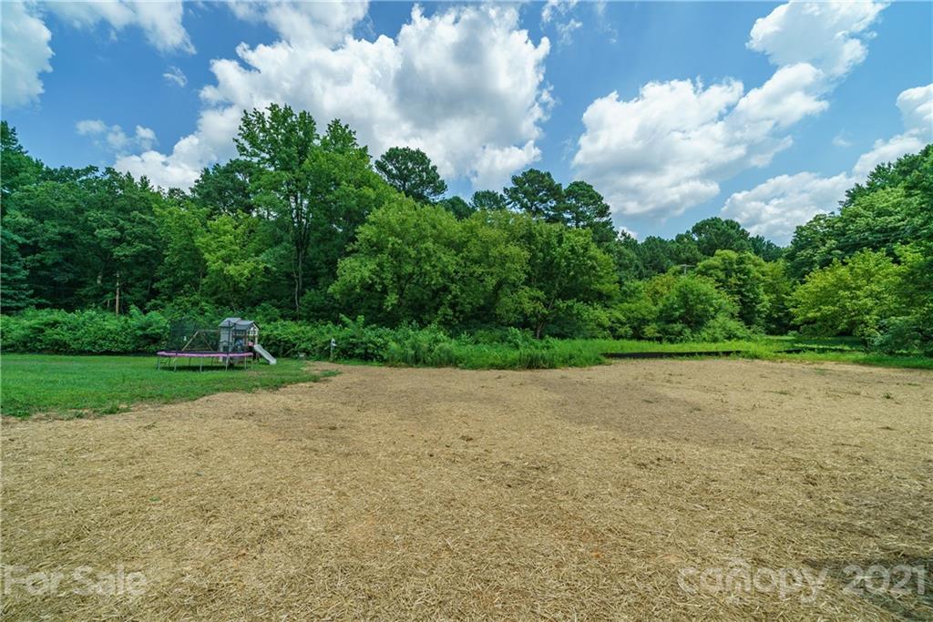 1802 Love Road Monroe, NC 28110 - Photo 6 of 48 a view of a field with plants in the background