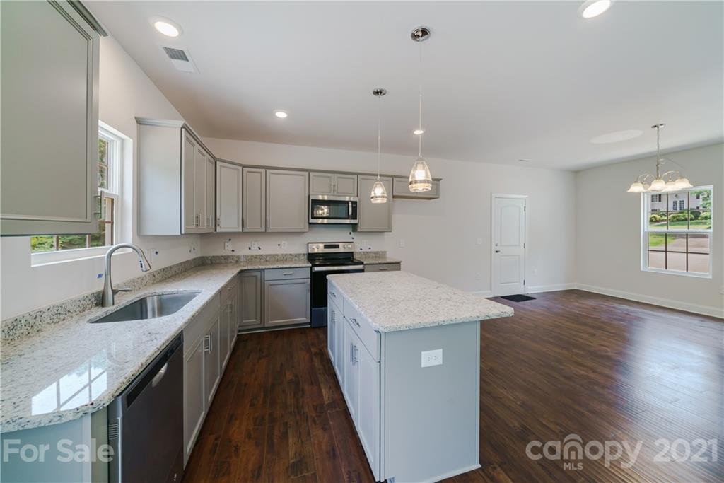 1802 Love Road Monroe, NC 28110 - Photo 9 of 48 a kitchen with a sink stove and cabinets