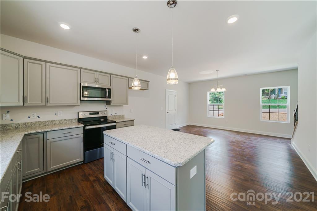 1802 Love Road Monroe, NC 28110 - Photo 10 of 48 a kitchen with granite countertop a sink stove and microwave