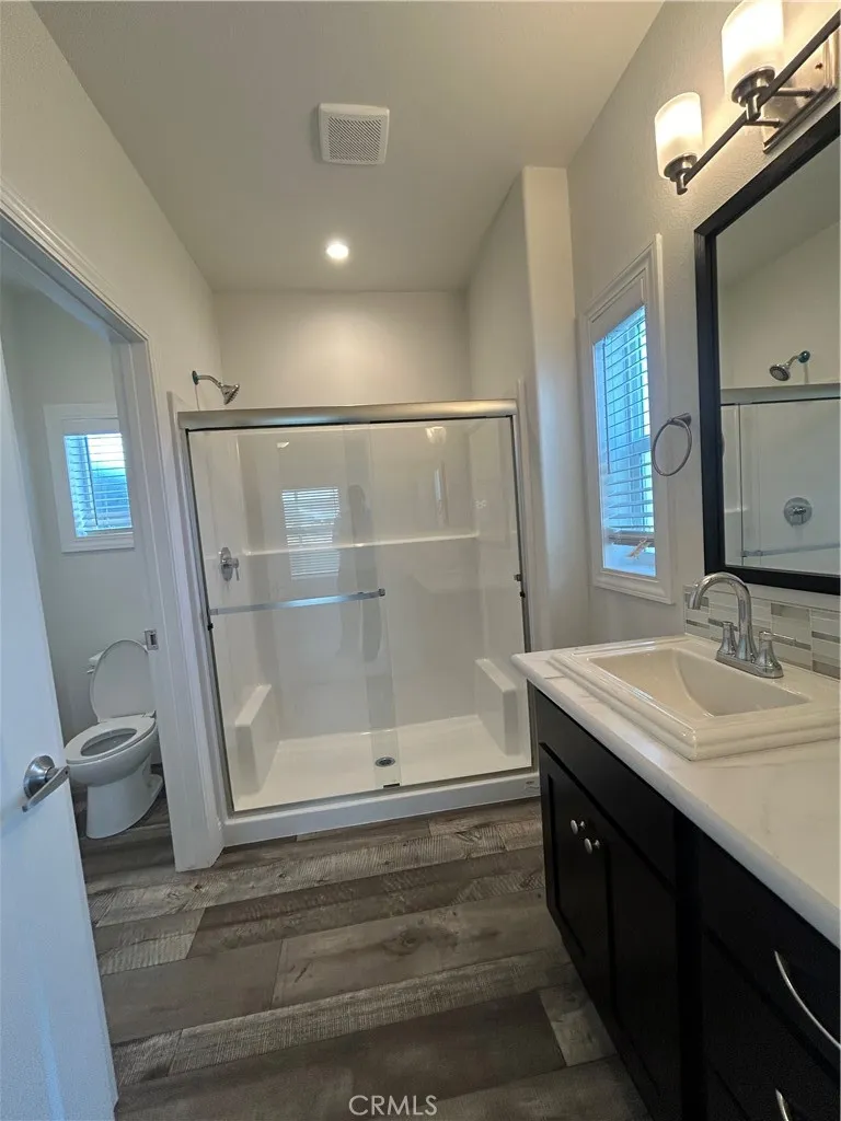 600 Gladstone, Unit 45 Azusa, CA 91702 - Photo 13 of 16 a bathroom with a sink a mirror and a shower