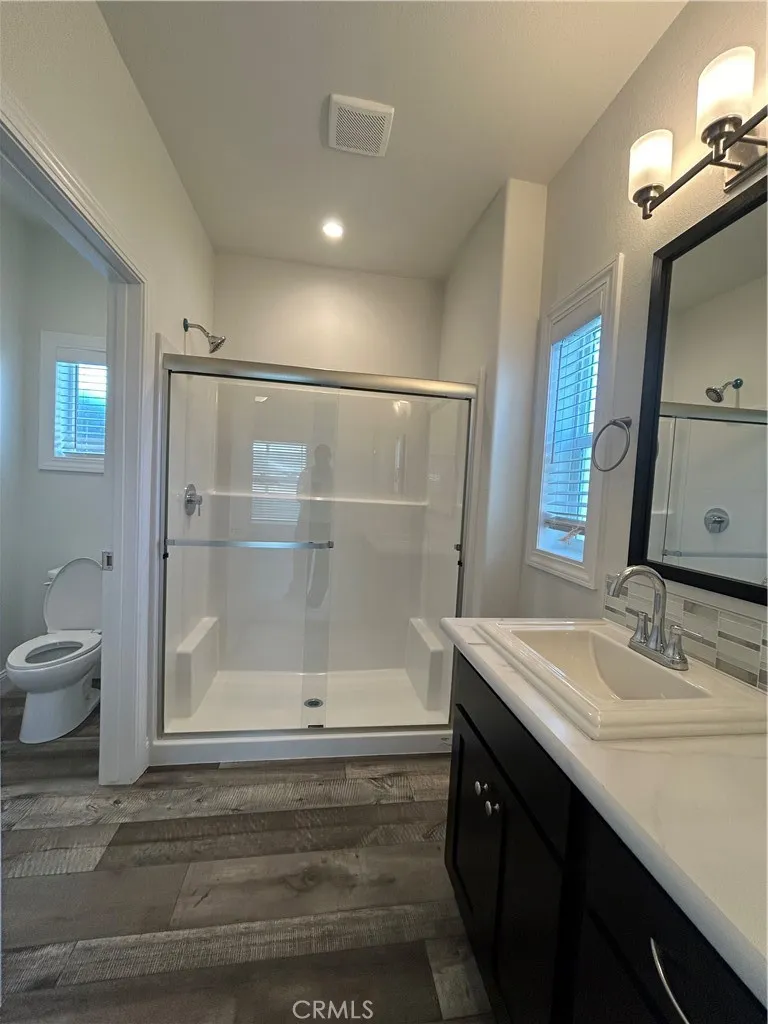 600 Gladstone, Unit 45 Azusa, CA 91702 - Photo 14 of 16 a bathroom with a sink a toilet a mirror and shower