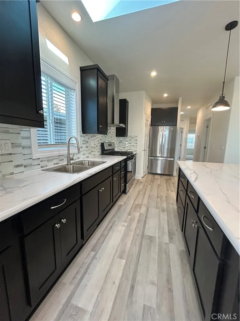 600 Gladstone, Unit 45 Azusa, CA 91702 - Photo 7 of 16 a large kitchen with a sink and large mirror