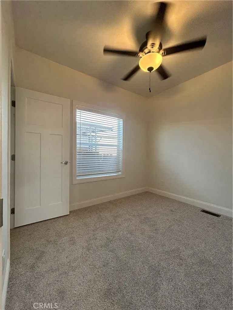 600 Gladstone, Unit 45 Azusa, CA 91702 - Photo 10 of 16 an empty room with a chandelier fan and windows