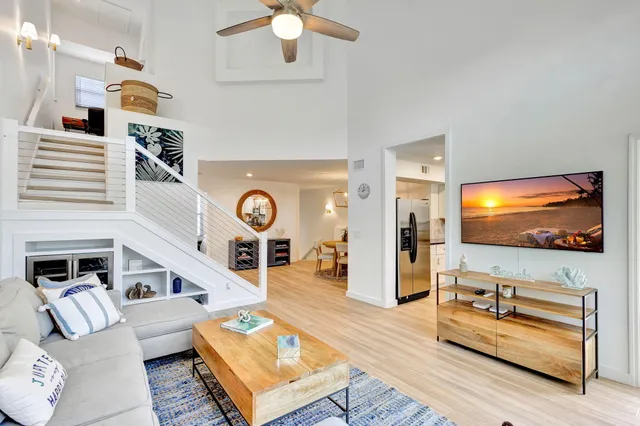 a kitchen with stainless steel appliances granite countertop a refrigerator a stove and a sink